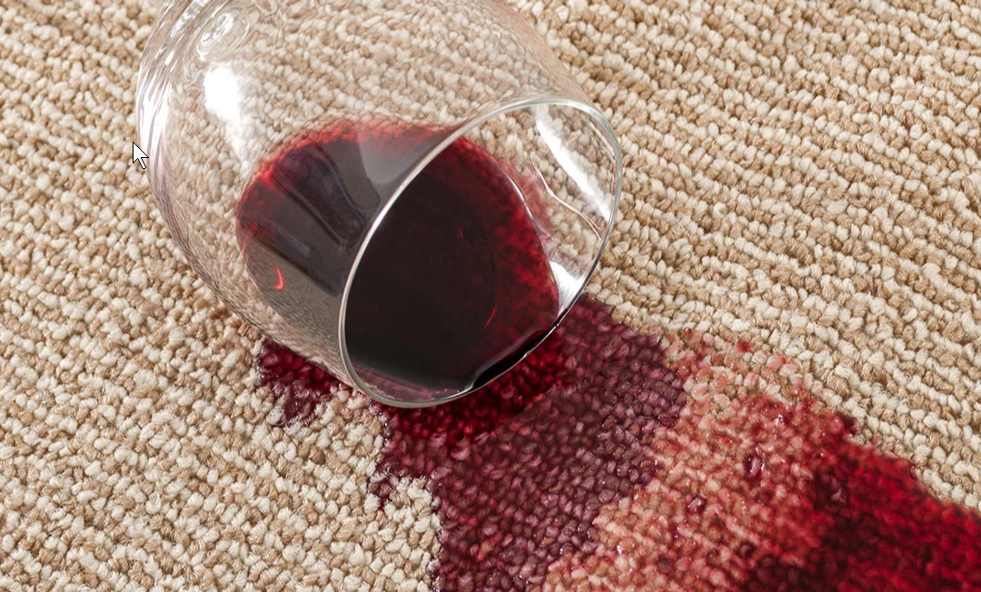 Spilled glass of red wine on rug